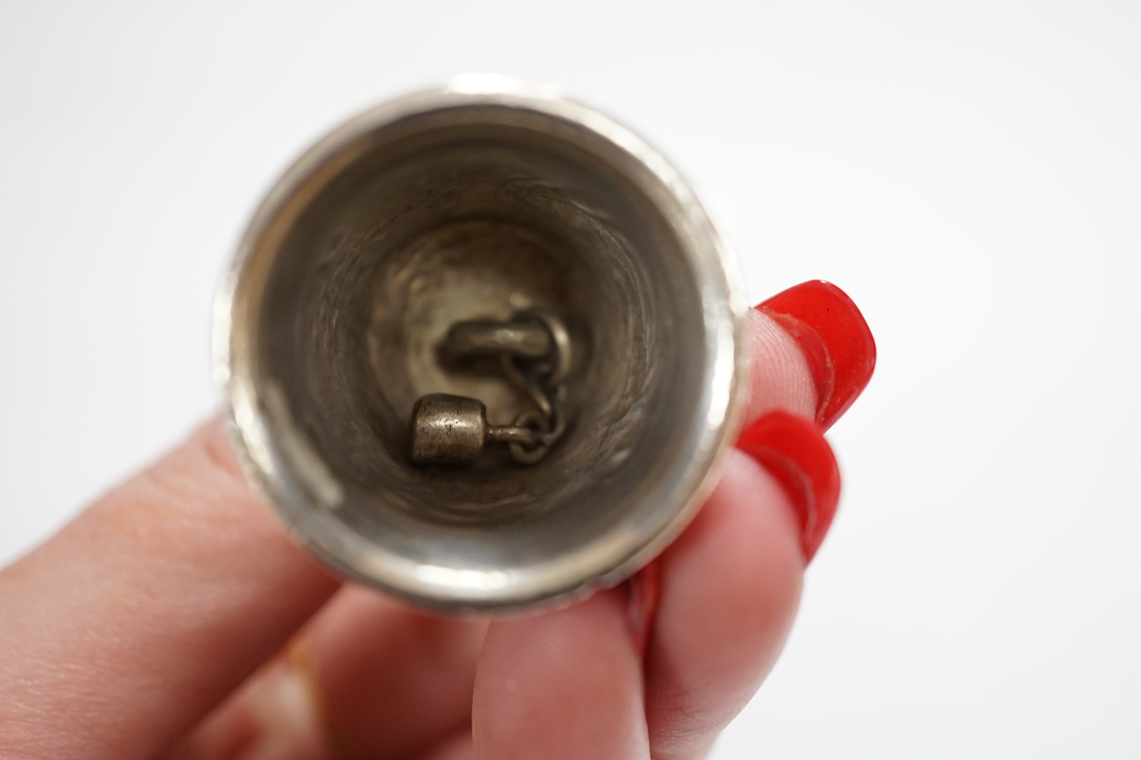 An early 20th century Hanau? miniature figural table bell, 46mm, a late Victorian silver combination paper knife and pencil, Arthur Downing Ltd?, Birmingham, 1897 and a late Victorian silver and Scottish hardstone set ri